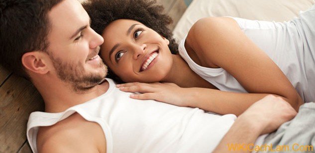 Smiling African woman lying in bed with her boyfriend.; Shutterstock ID 139129913; PO: aol; Job: production; Client: drone